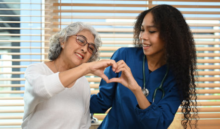 two woman engaging in a gesture of affection and care